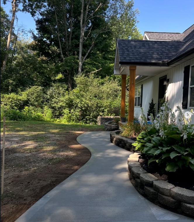 Curved front walk with block retaining wall — concrete work by Loaded Construction in metro Detroit
