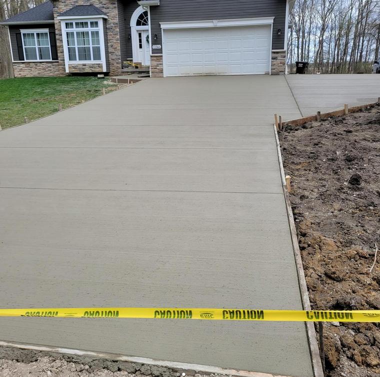 Fresh pour, wide front approach — concrete work by Loaded Construction in metro Detroit